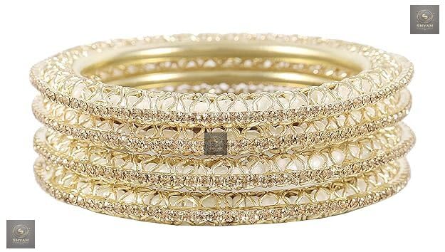 Golden kada set with artificial pearls and zircon gemstones in an intricate curved pattern.
