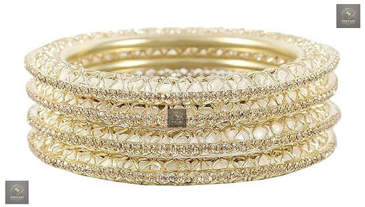 Golden kada set with artificial pearls and zircon gemstones in an intricate curved pattern.