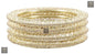 Golden kada set with artificial pearls and zircon gemstones in an intricate curved pattern.