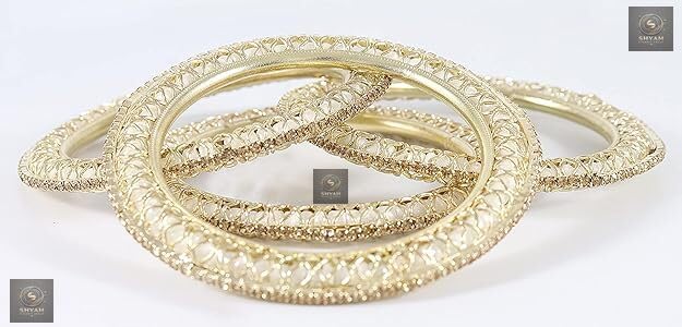 Golden kada set with artificial pearls and zircon gemstones in an intricate curved pattern.