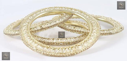 Golden kada set with artificial pearls and zircon gemstones in an intricate curved pattern.